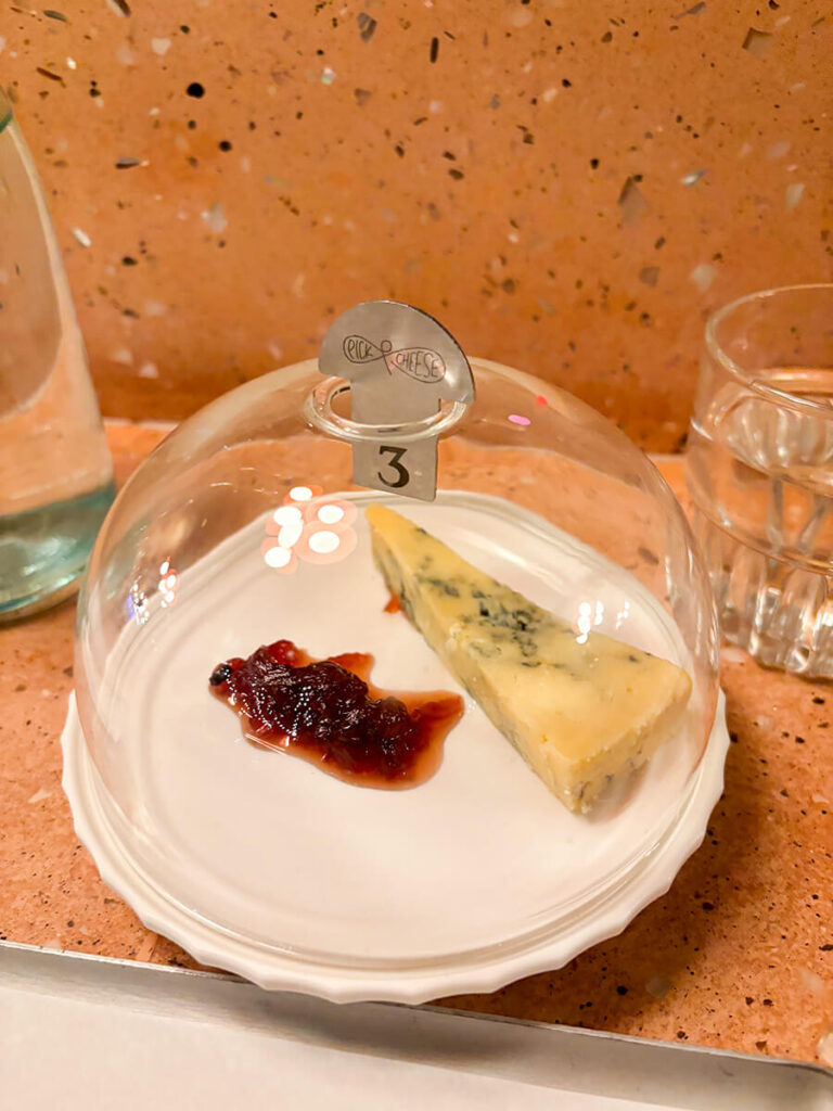 A plate of blue cheese paired with jam from Pick & Cheese, a conveyor belt cheese bar London in the Seven Dials Market