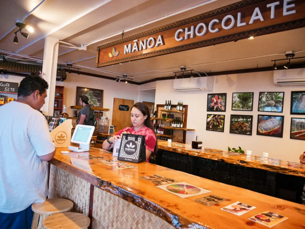 Hispanic/Filipino man at Manoa Chocolate Tour to purchase chocolate bars in Kailua, Hawaii.