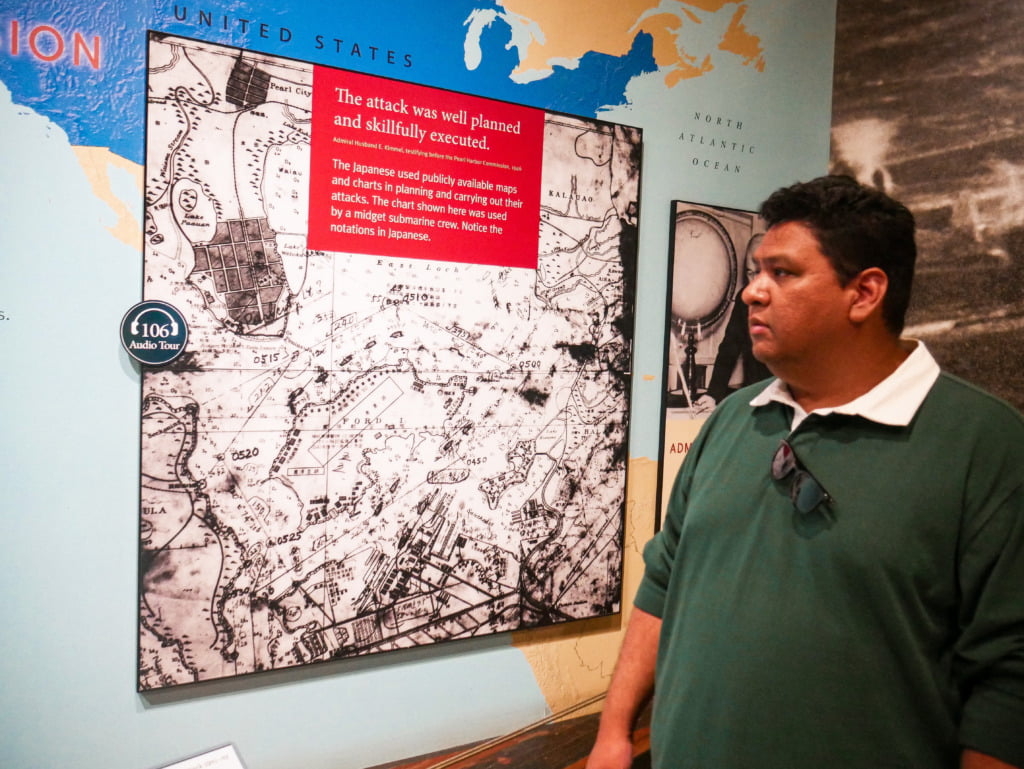 Man looking at map of Japan's plans to attack Pearl Harbor, featured in the Exhibit Gallery