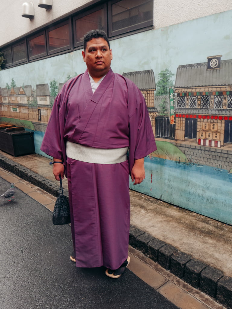 Man wearing purple kimono in the streets of Asakusa, Tokyo, Japan
