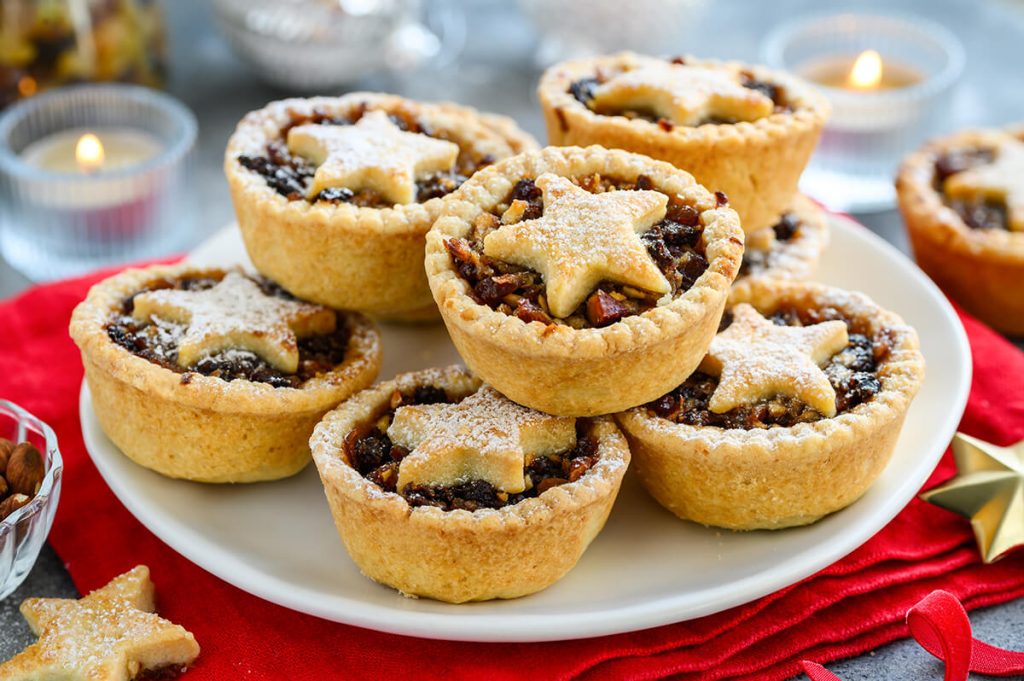 A plate of mince pies, a British dessert pie filled with fruit and meat, often served during Christmas
