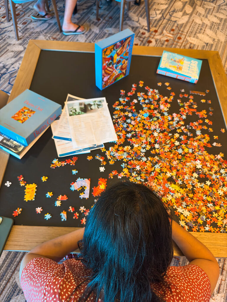 Hannah playing puzzles on the game room on Holland America Zaandam