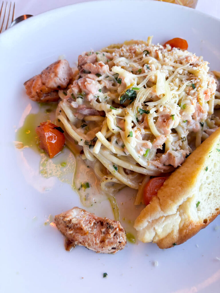 seafood pasta with a side of bread from the main dining hall in Holland America Zaandam
