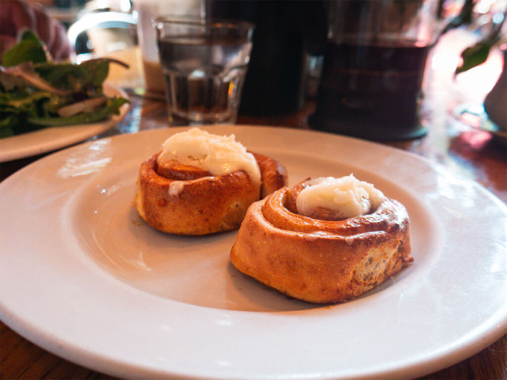 2 cinnamon rolls on a plate from Twisted Fork in Gastown in Vancouver
