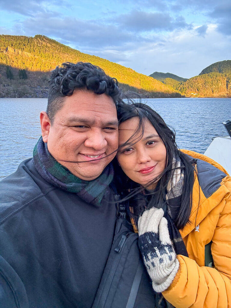 Hannah and Cecilio on the sundeck on a ferry sailing through the Mostraumen fjord cruise from Bergen, Norway
