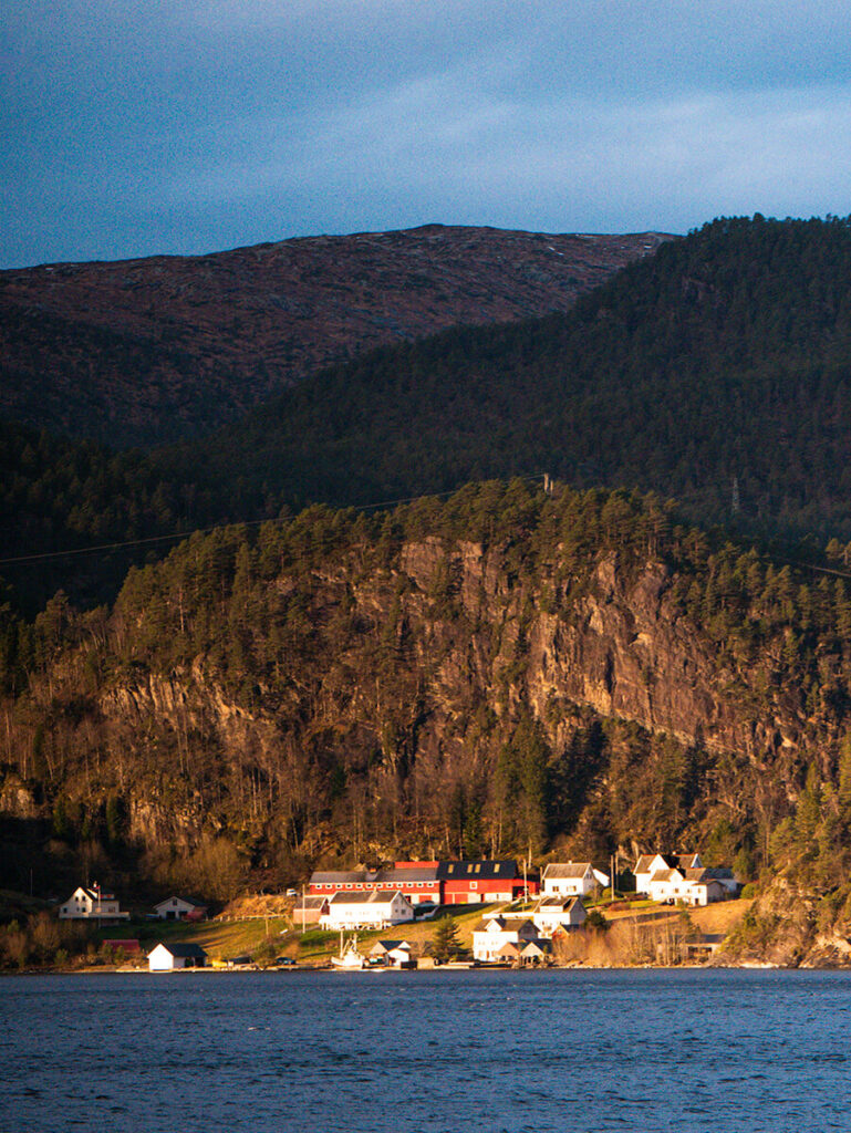 Villages with mountains behind along the Osterfjord in Norway