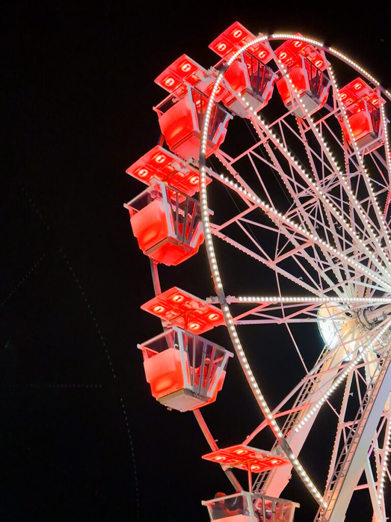 Ferris wheel at the Bergen Christmas Market in Norway, lit up in red colors