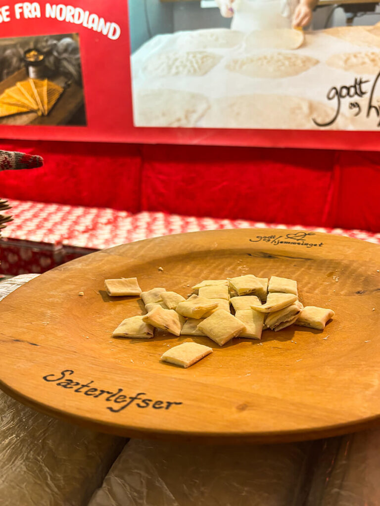 Samples of lefse at the Bergen Christmas market. Served on a wooden plate with the word "sæterlefser" engraved