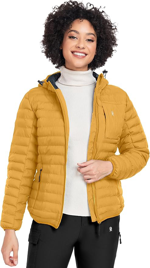 light skinned African American lady wearing a yellow puffer jacket, beige turtleneck top, and black pants
